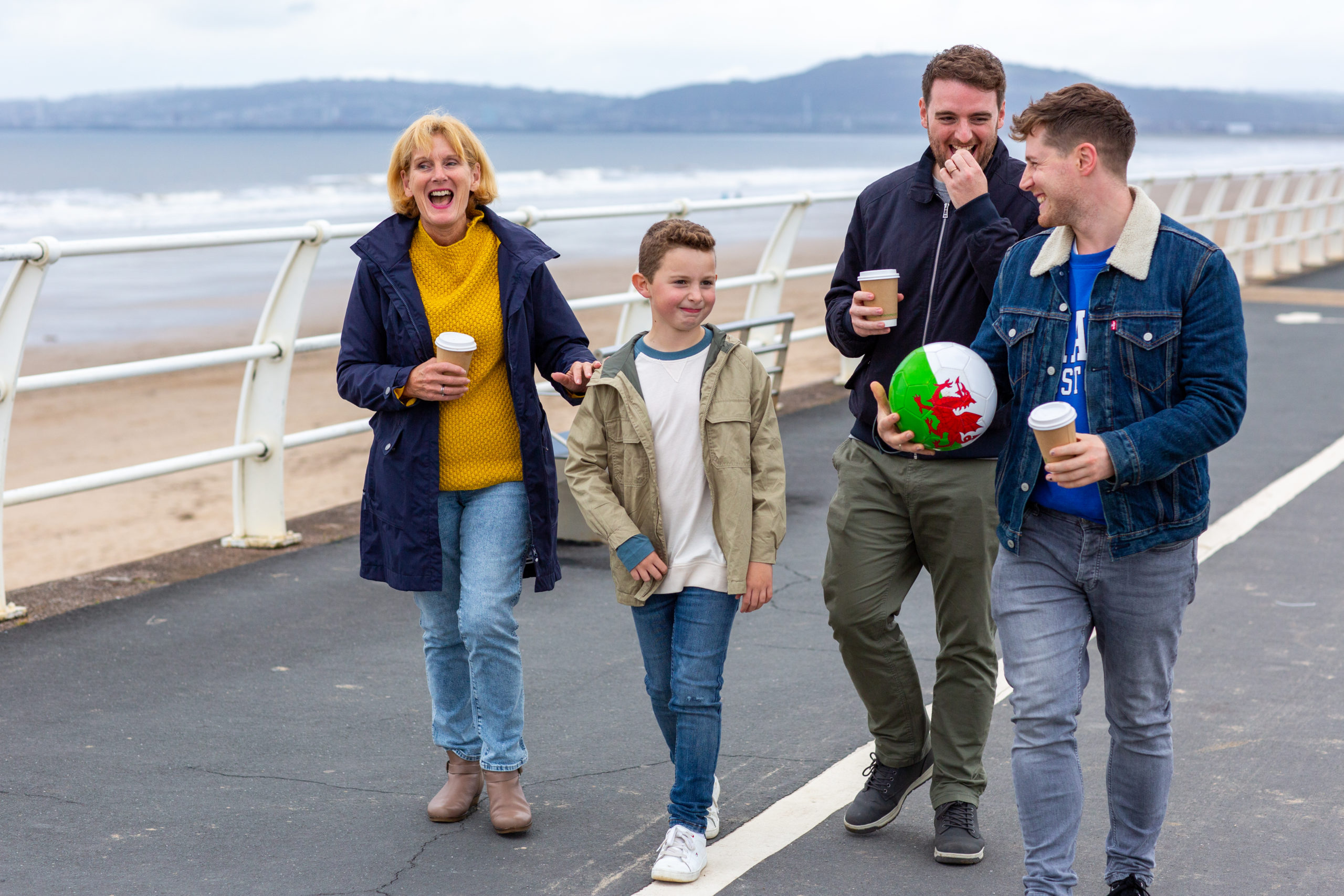 family smiling and walking on the beach