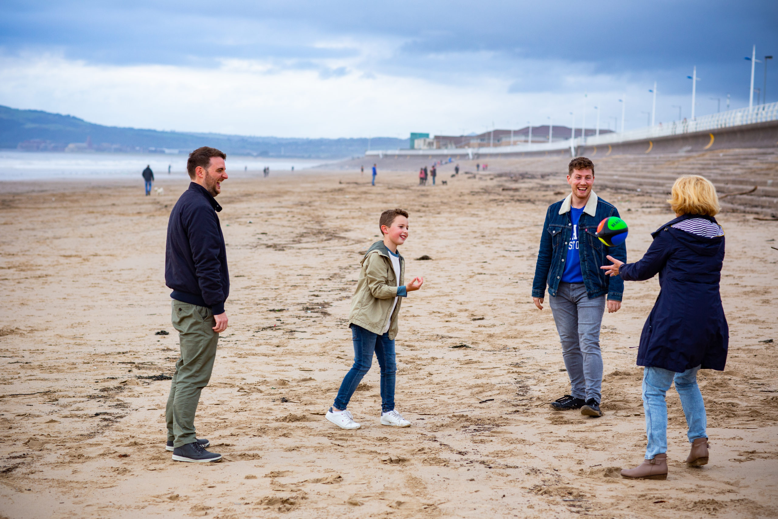 family playing on the beach