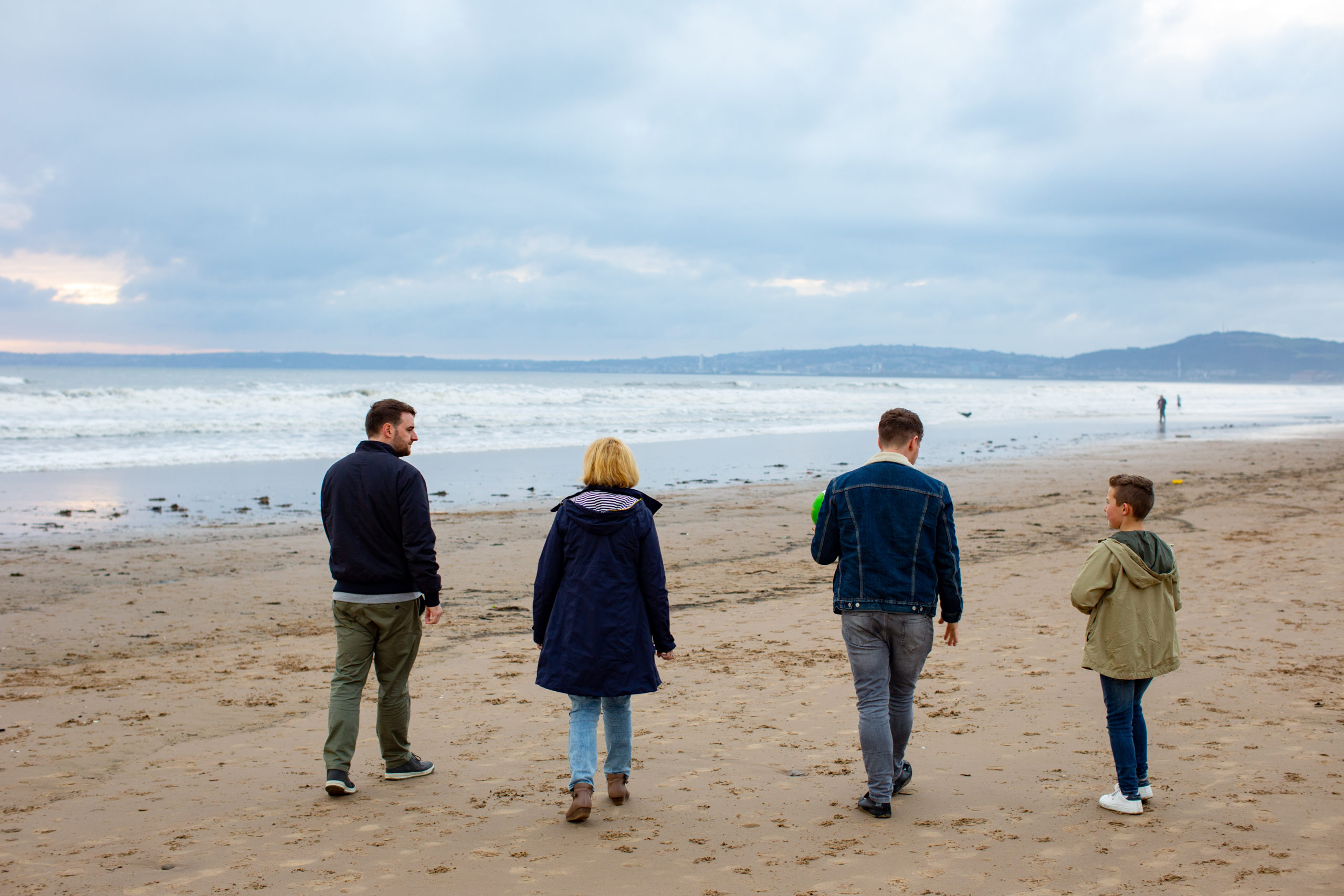 family walking along a beach