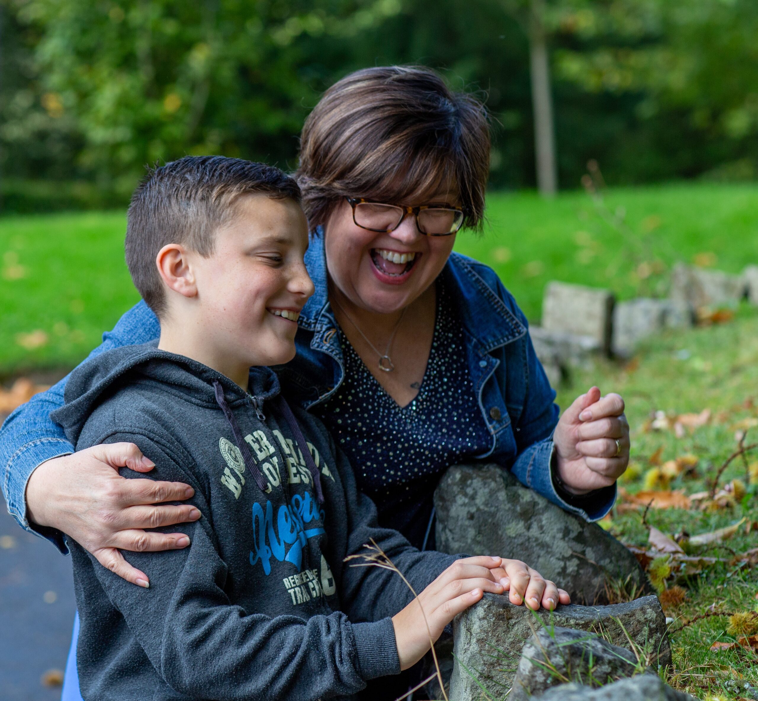 Female foster carer and young boy smiling